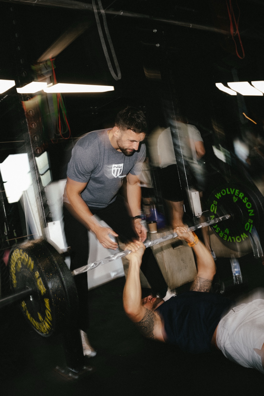 Alex Kitchen coaching a client in the gym